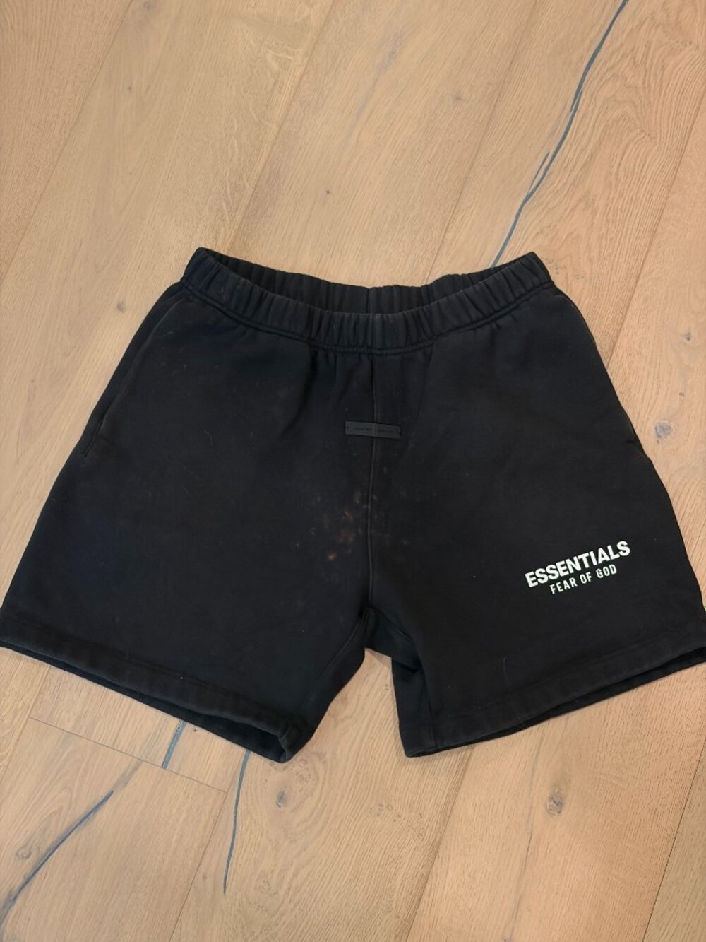 Fear of God Essentials Mens Black Shorts with bleach stains